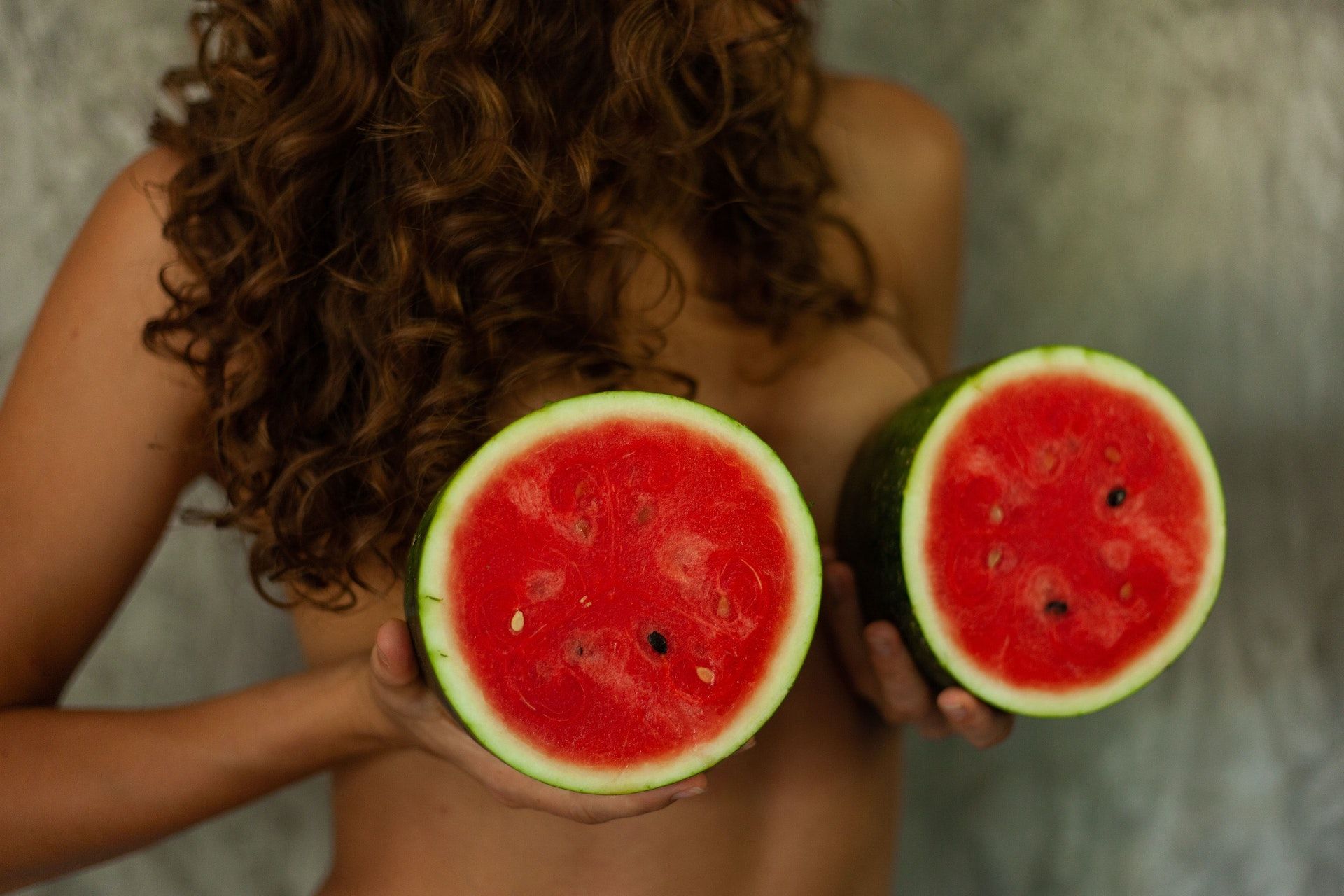 Woman holding watermelons